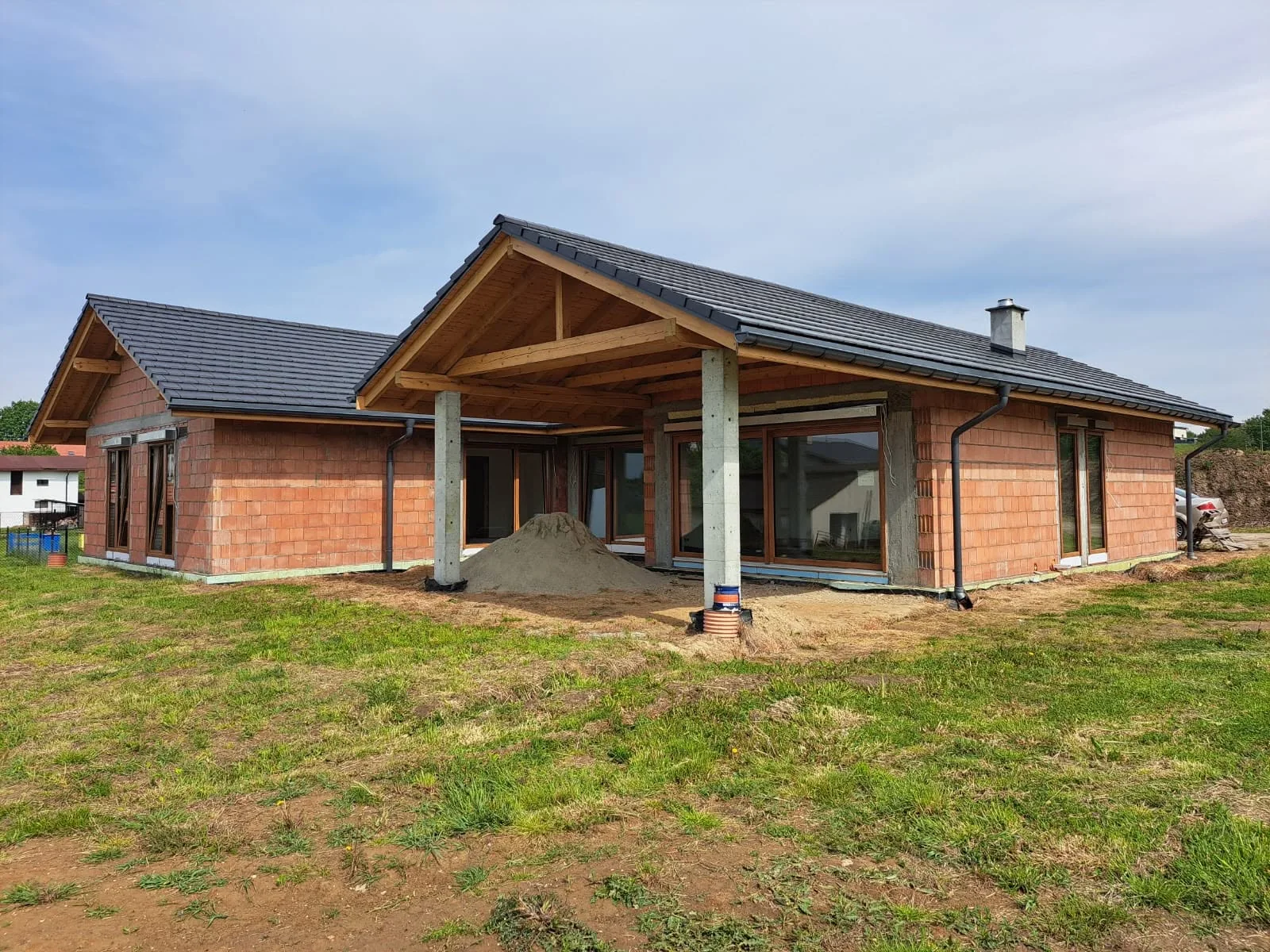 The same house during construction, timber roof structure already in place